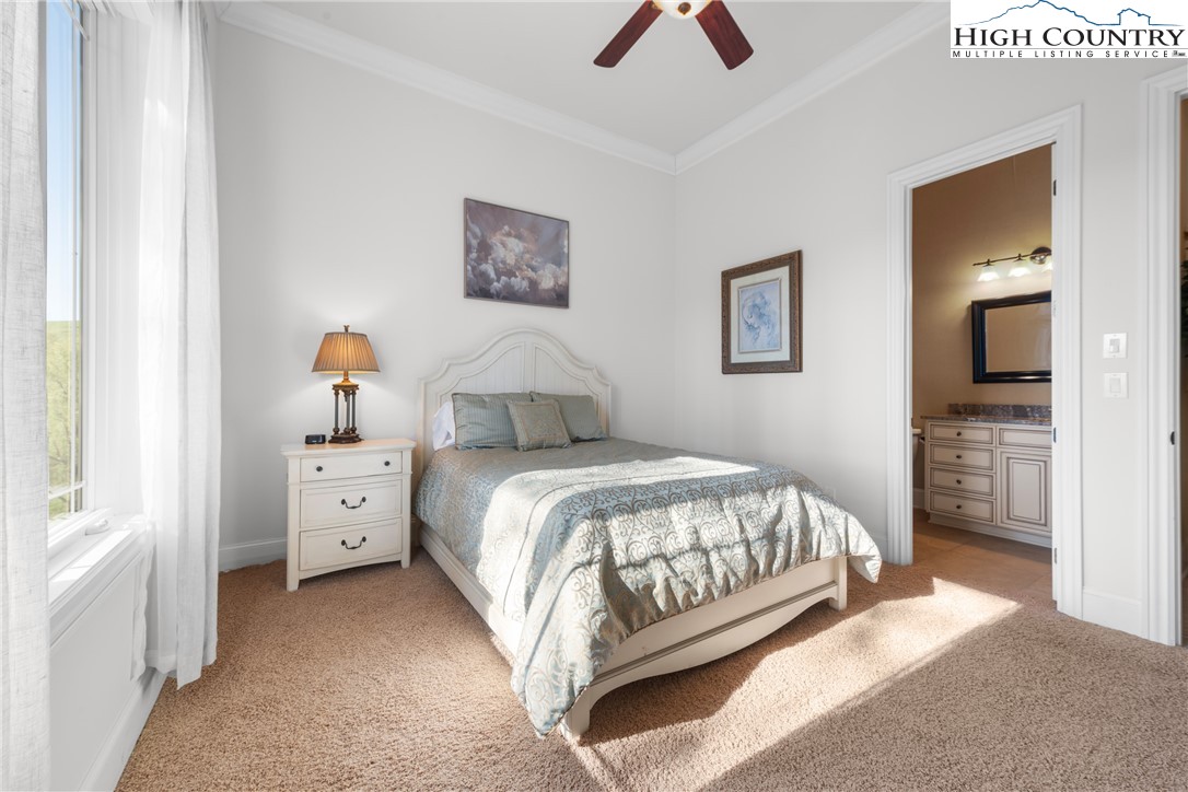 46 North Ridge Lane Newland, NC 28657 - Photo 30 of 46 a bedroom with a bed and a chandelier