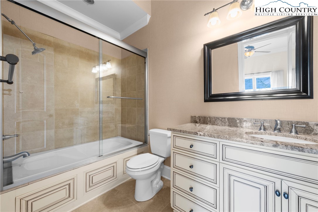 46 North Ridge Lane Newland, NC 28657 - Photo 31 of 46 a bathroom with a granite countertop toilet sink and mirror