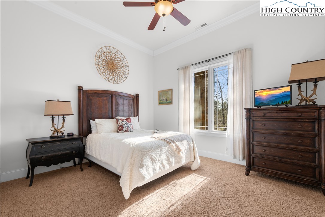 46 North Ridge Lane Newland, NC 28657 - Photo 32 of 46 a bedroom with a bed and a lamp on dresser