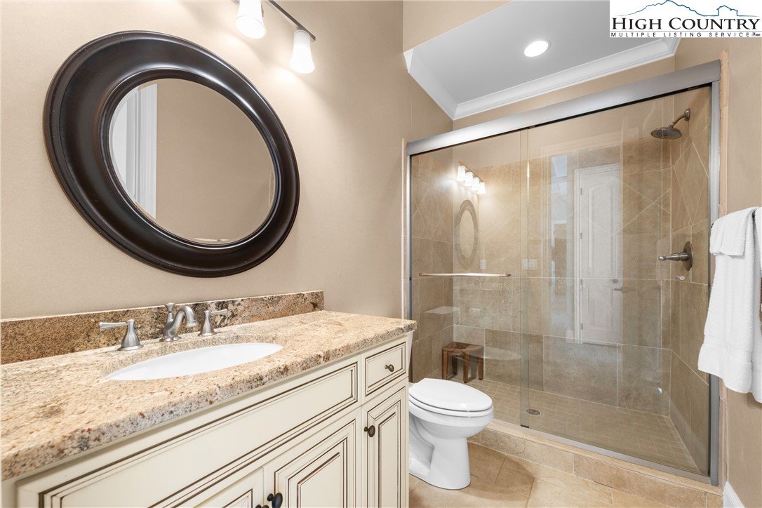 46 North Ridge Lane Newland, NC 28657 - Photo 33 of 46 a bathroom with a granite countertop sink toilet mirror vanity and shower