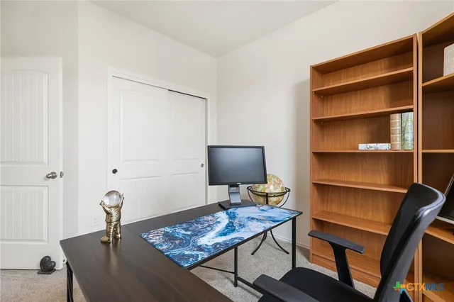 a view of a workspace with furniture