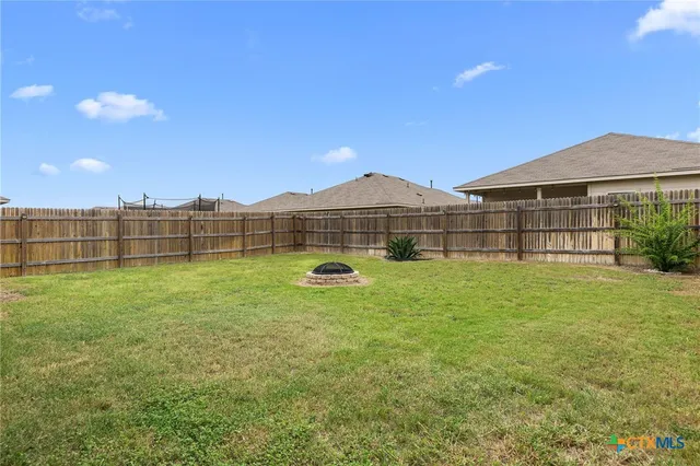 a view of a garden with a wooden fence