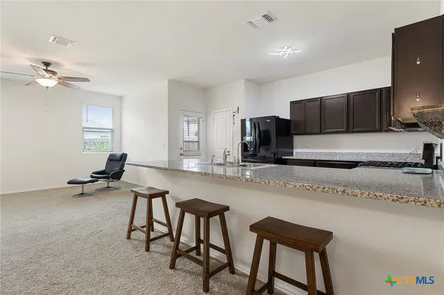 a hall with a chair a sink and a couch