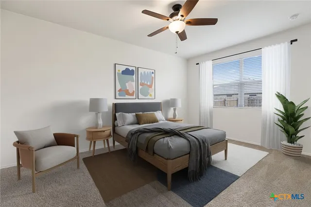 a bedroom with furniture and a large window