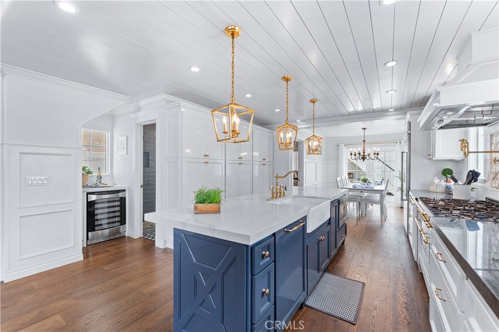 208 Indianapolis Avenue Huntington Beach, CA 92648 - Photo 13 of 66 a kitchen with lots of counter space and wooden floor