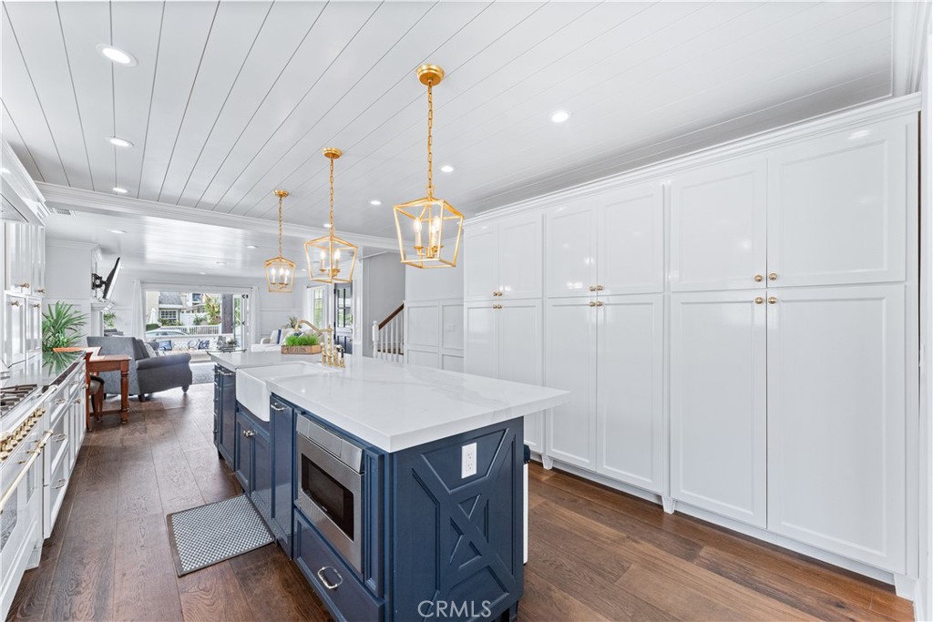 208 Indianapolis Avenue Huntington Beach, CA 92648 - Photo 14 of 66 a kitchen that has a lot of cabinets in it