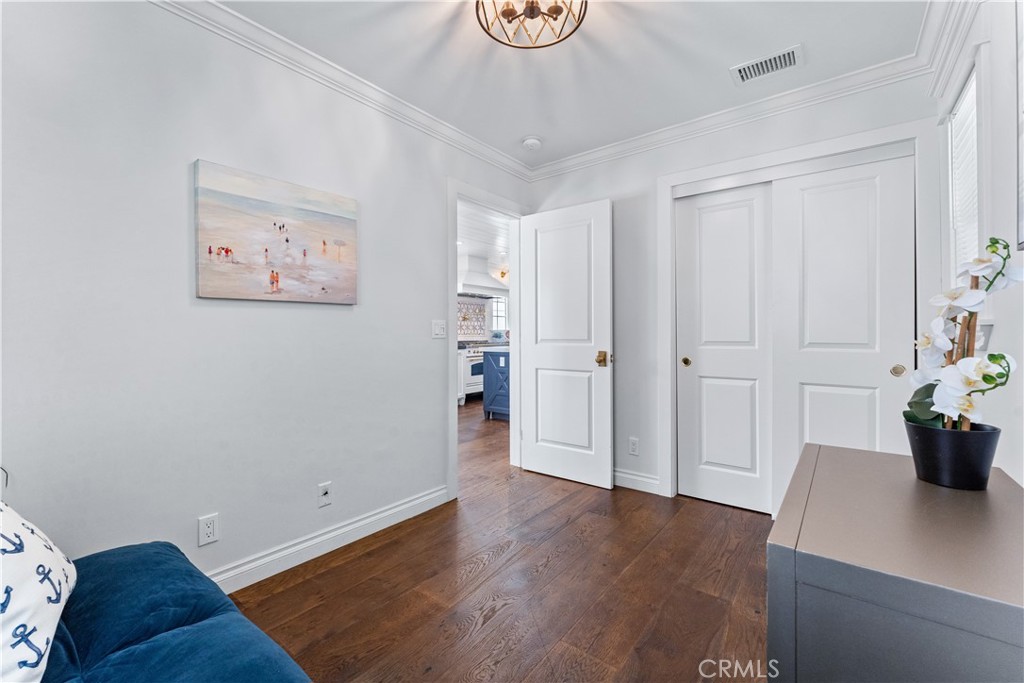 208 Indianapolis Avenue Huntington Beach, CA 92648 - Photo 20 of 66 a view of an empty room with wooden floor