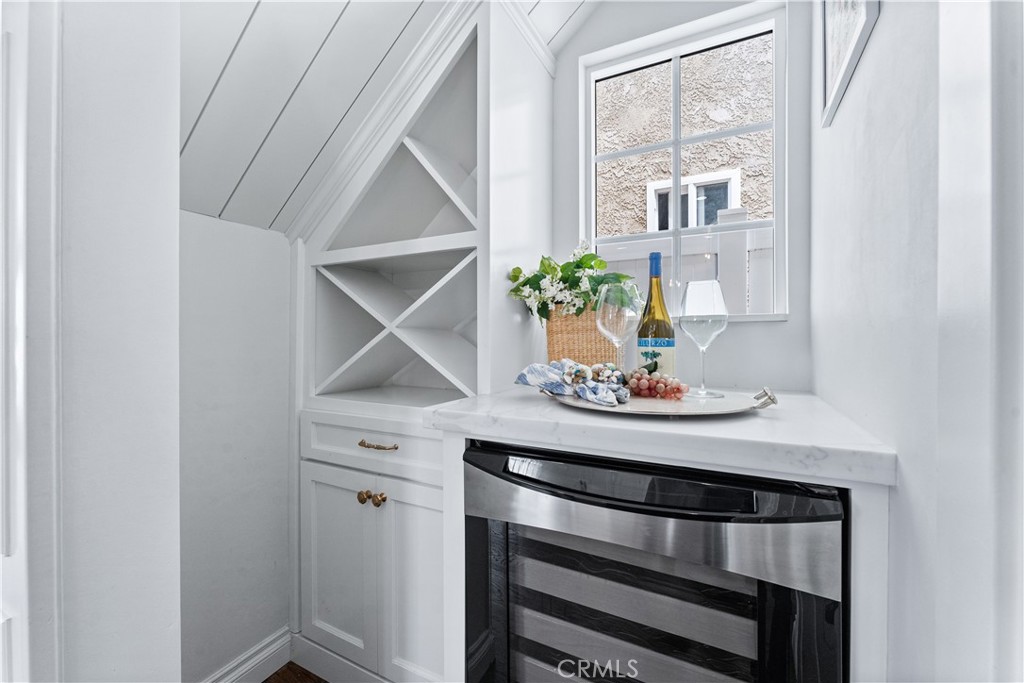 208 Indianapolis Avenue Huntington Beach, CA 92648 - Photo 21 of 66 a table with a stove and white cabinets