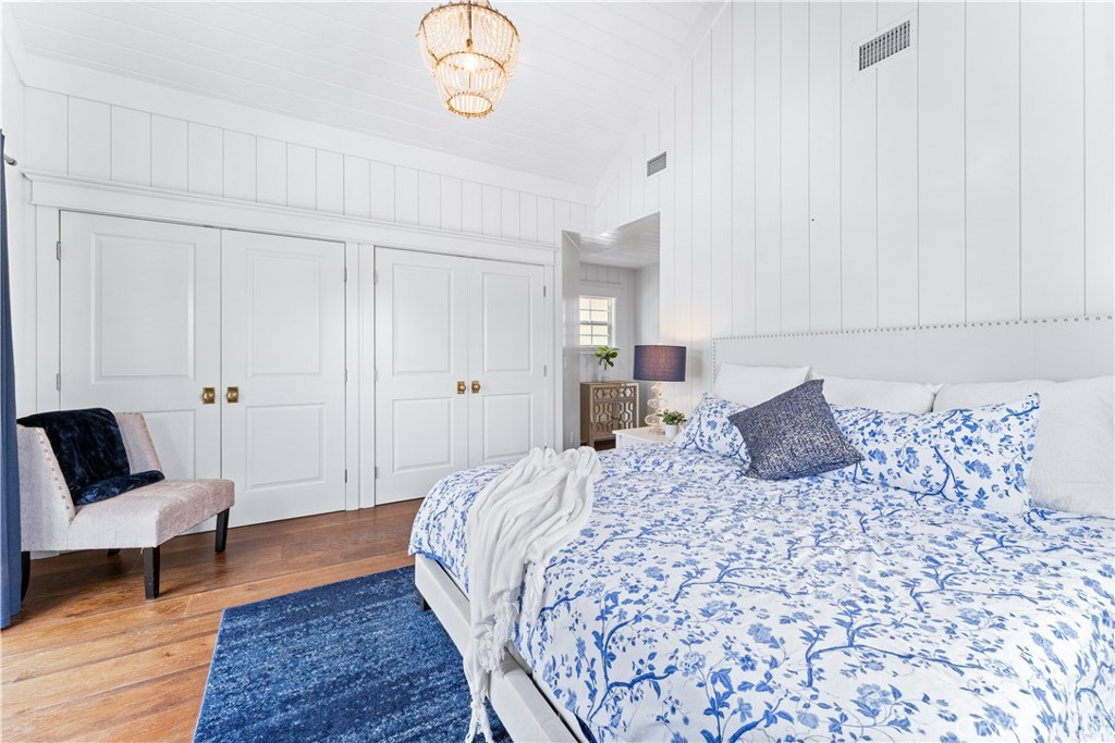 208 Indianapolis Avenue Huntington Beach, CA 92648 - Photo 24 of 66 a bedroom with a large bed and a chair