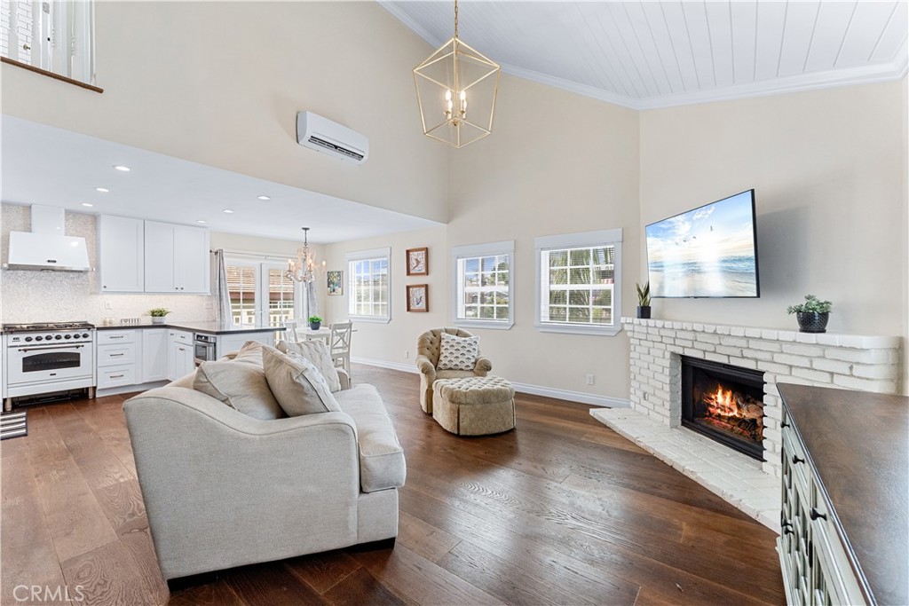 208 Indianapolis Avenue Huntington Beach, CA 92648 - Photo 36 of 66 a living room with furniture and a fireplace