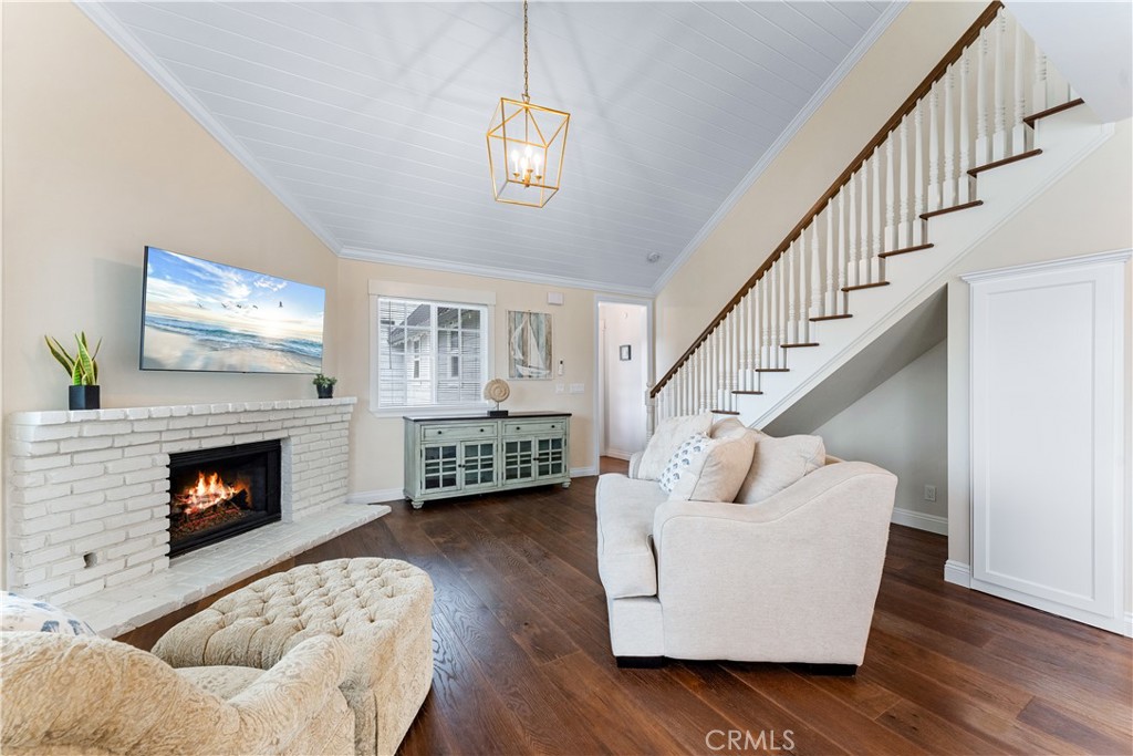 208 Indianapolis Avenue Huntington Beach, CA 92648 - Photo 37 of 66 a living room with furniture and a fireplace