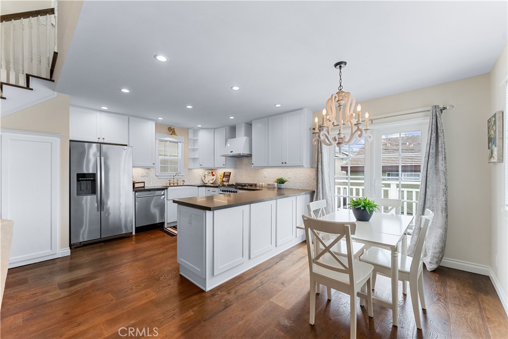 208 Indianapolis Avenue Huntington Beach, CA 92648 - Photo 40 of 66 a kitchen with stainless steel appliances granite countertop a sink refrigerator and microwave