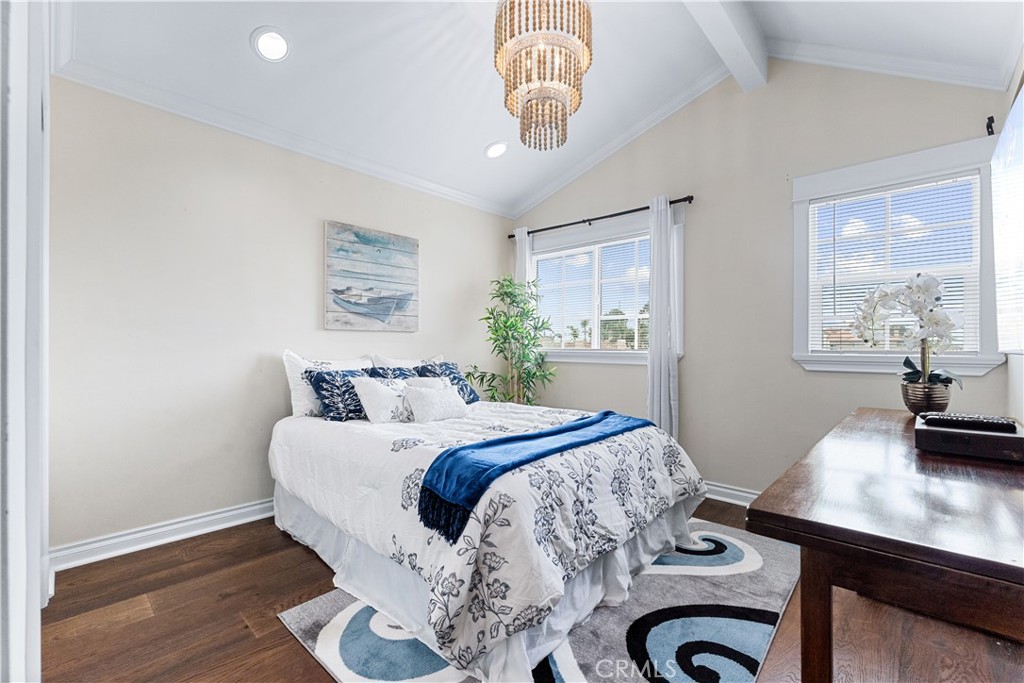 208 Indianapolis Avenue Huntington Beach, CA 92648 - Photo 42 of 66 a bedroom with a bed and a table in it