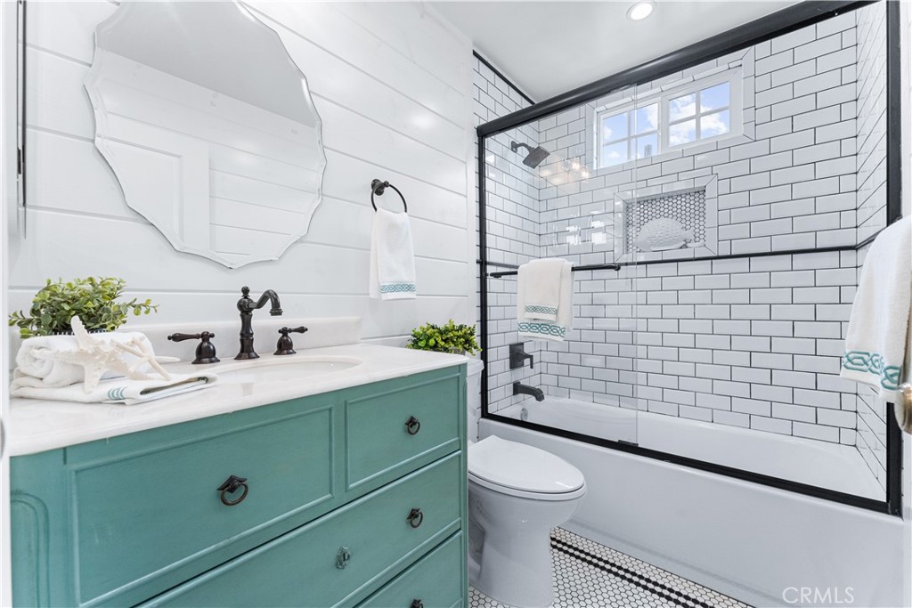 208 Indianapolis Avenue Huntington Beach, CA 92648 - Photo 44 of 66 a bathroom with a sink mirror vanity and toilet