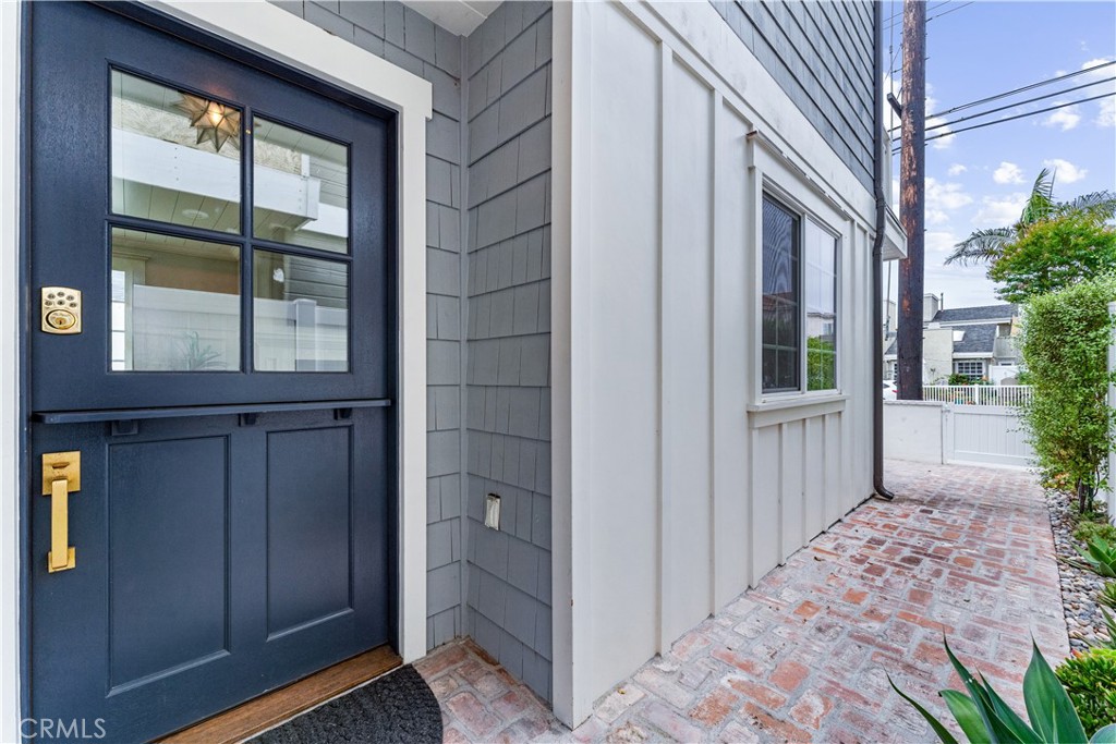 208 Indianapolis Avenue Huntington Beach, CA 92648 - Photo 5 of 66 a view of a house with a door and wooden walls
