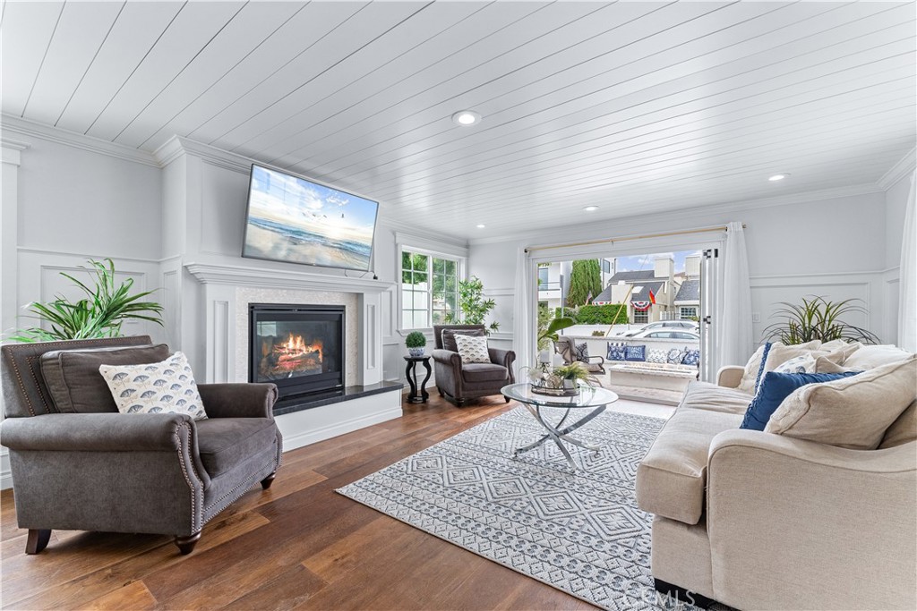208 Indianapolis Avenue Huntington Beach, CA 92648 - Photo 6 of 66 a living room with furniture and a fireplace