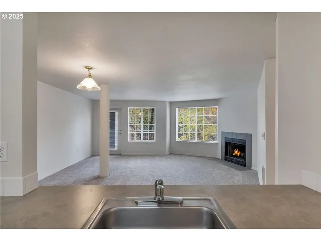 a view of living room with furniture and a fireplace