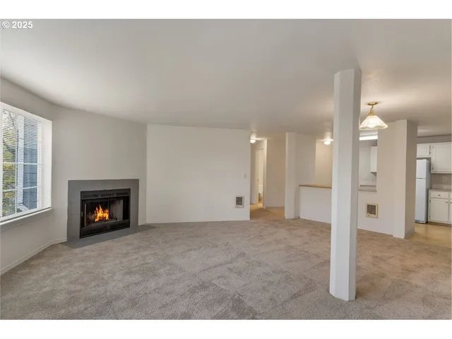 a view of an empty room with a fireplace