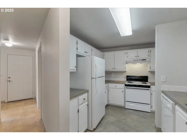 a kitchen with a stove a refrigerator and a sink