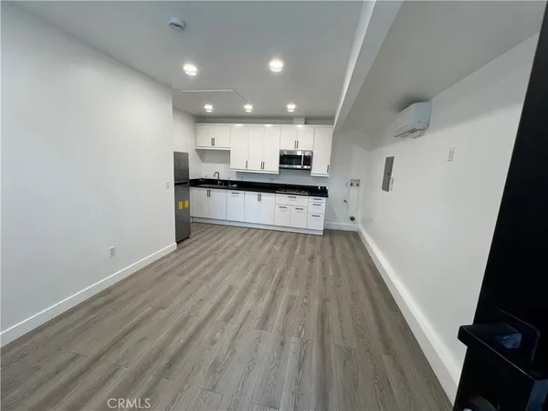 a view of kitchen with sink microwave and stove