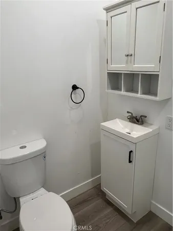 a white toilet sitting next to a bathroom sink