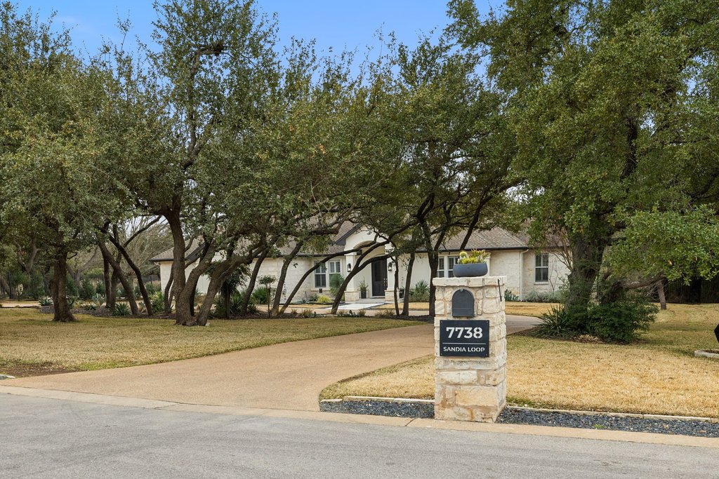 7738 Sandia Loop Austin, TX 78735 - Photo 2 of 40 a sign board with yard and trees