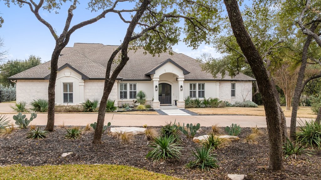 7738 Sandia Loop Austin, TX 78735 - Photo 3 of 40 a front view of a house with yard and garage