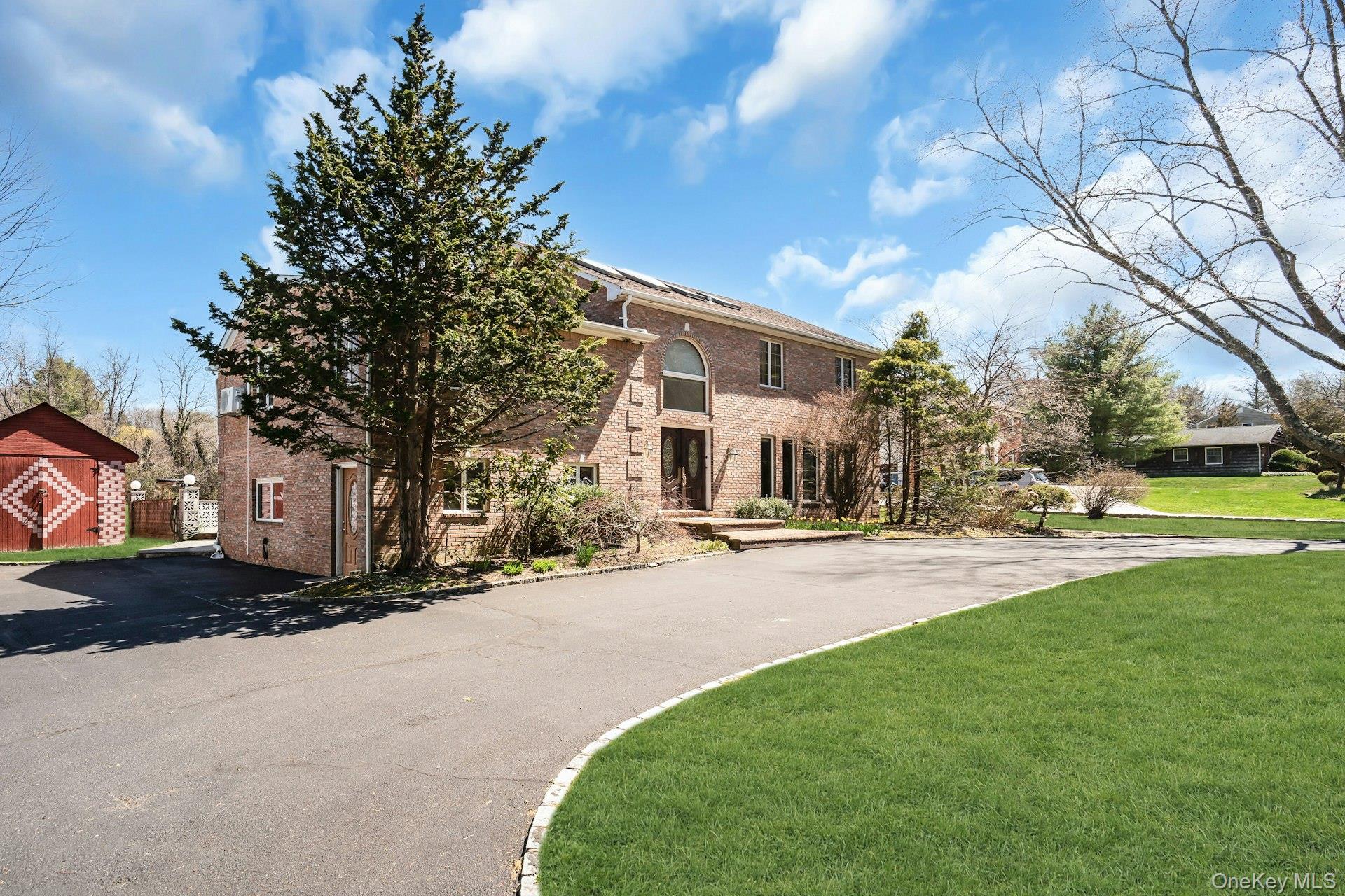 12 Bagatelle Road Dix Hills, NY 11746 - Photo 3 of 48 a view of a house with a yard and large trees