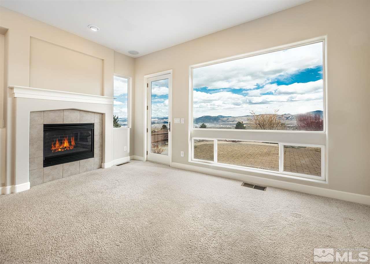 620 Rabbit Ridge Court Reno, NV 89511 - Photo 3 of 34 a view of an empty room with a fireplace