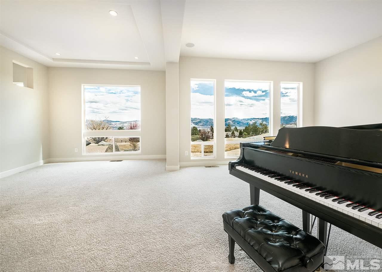 620 Rabbit Ridge Court Reno, NV 89511 - Photo 8 of 34 a living room with furniture and a floor to ceiling window