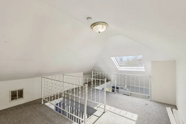 a view of staircase with white walls