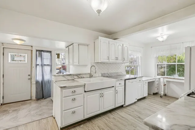 a kitchen with a sink stove and cabinets