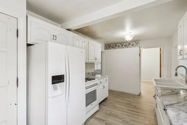a kitchen with stainless steel appliances a refrigerator sink and cabinets