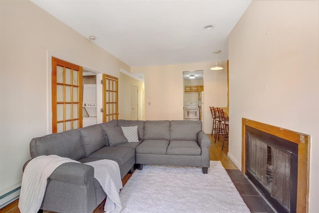 28 Symphony Road, Unit 3 Boston, MA 02115 - Photo 1 of 13 a living room with furniture and a fireplace