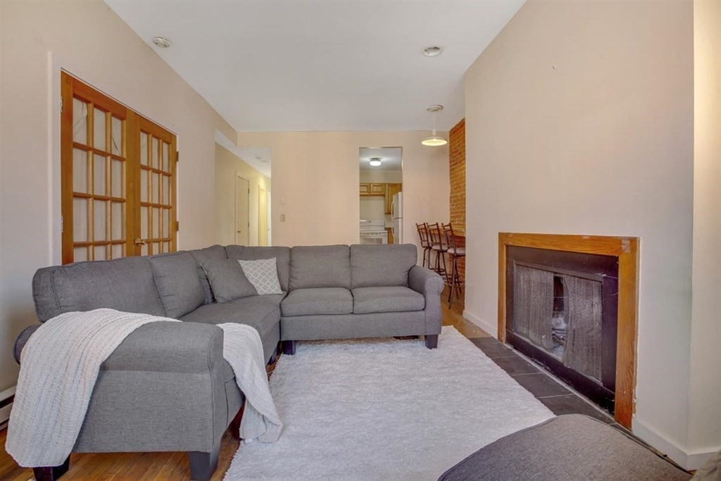 28 Symphony Road, Unit 3 Boston, MA 02115 - Photo 2 of 13 a living room with furniture and a fireplace