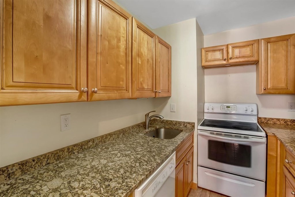 28 Symphony Road, Unit 3 Boston, MA 02115 - Photo 6 of 13 a kitchen with granite countertop cabinets stainless steel appliances and a counter space