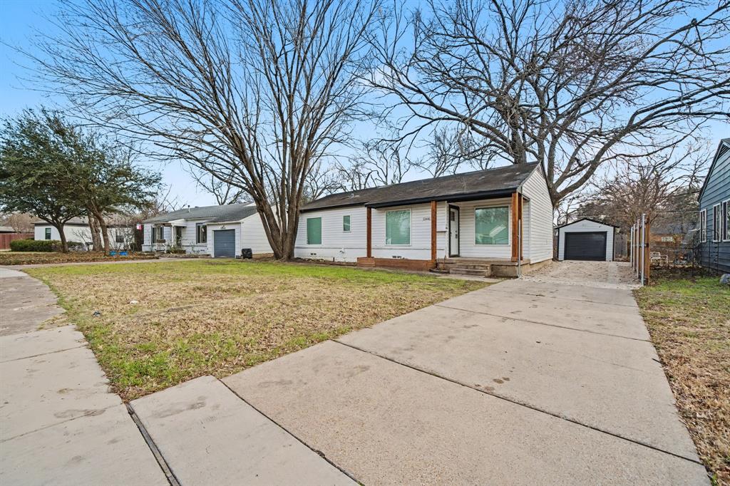 11446 Lippitt Avenue Dallas, TX 75218 - Photo 3 of 26 a front view of a house with a yard