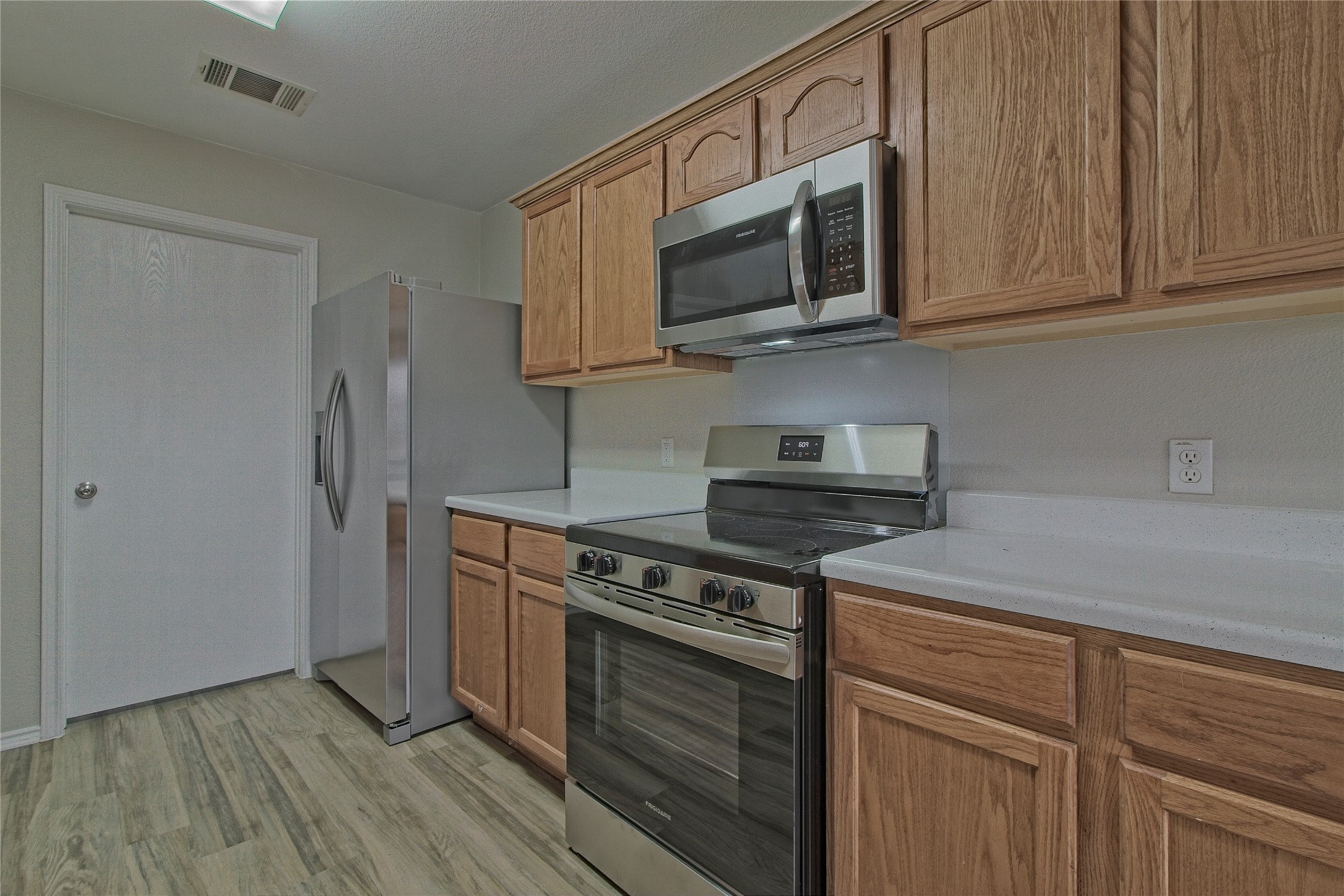 232 Brickyard Lane Jarrell, TX 76537 - Photo 15 of 31 A well-equipped culinary space featuring warm wood cabinetry and sleek stainless steel appliances.