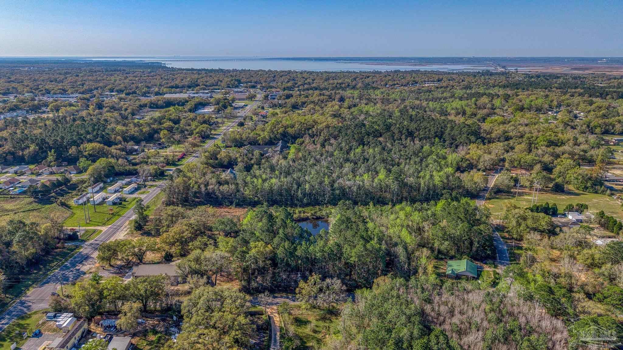 0 Guernsey Road Pace, FL 32571 - Photo 19 of 23 a view of a city with lots of trees