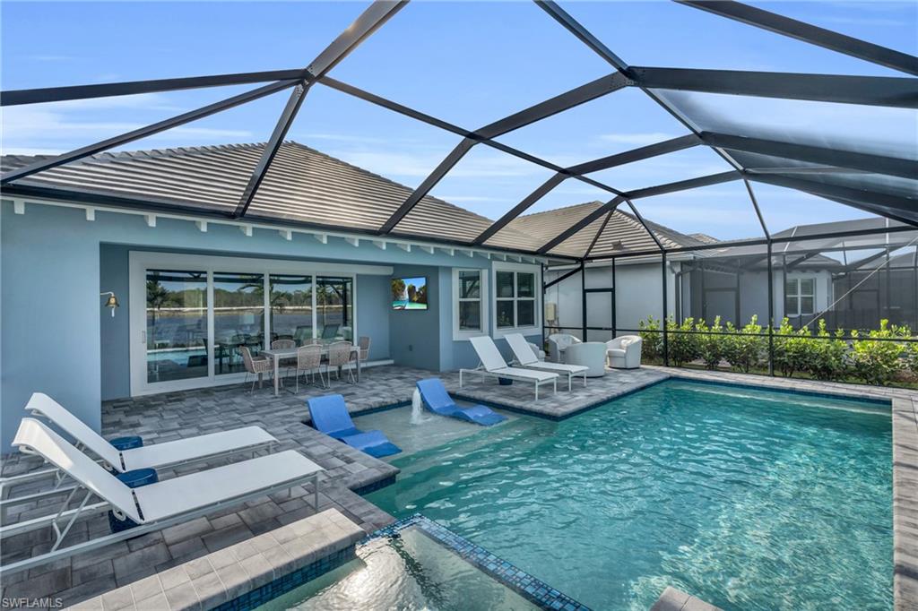 8795 Calypso Court Naples, FL 34113 - Photo 35 of 49 a view of a house with backyard sitting area and garden