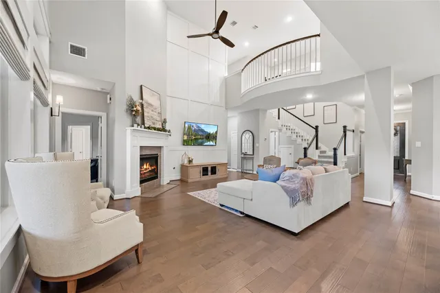 a living room with furniture a fireplace and a chandelier