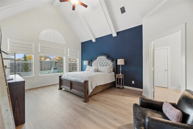 a bedroom with a bed and a large window