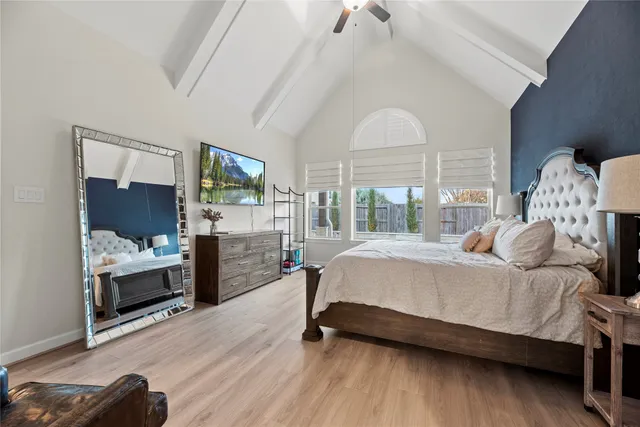 a spacious bedroom with a bed and a dresser