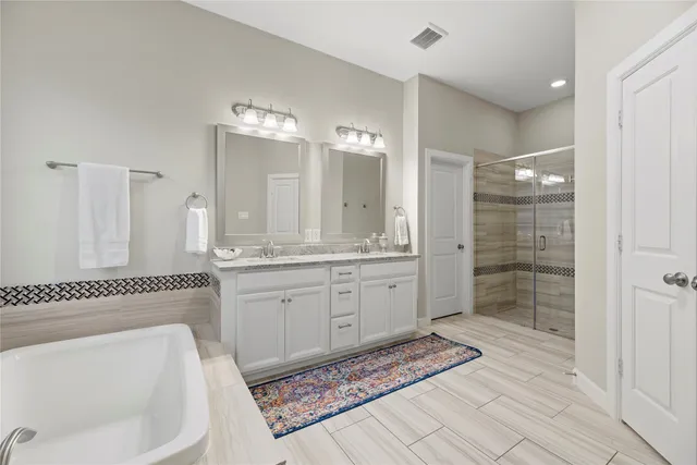 a spacious bathroom with a mirror a sink and a shower