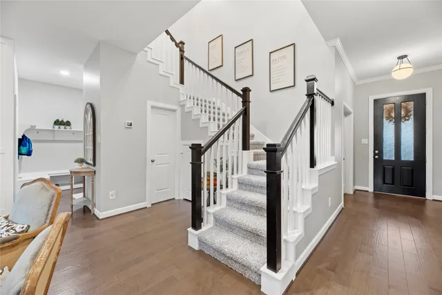 a view of a hallway with dining room and stairs