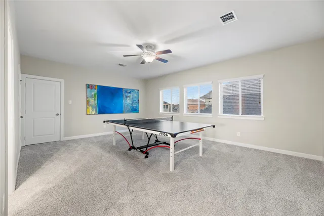 a living room with furniture a dining table and a window