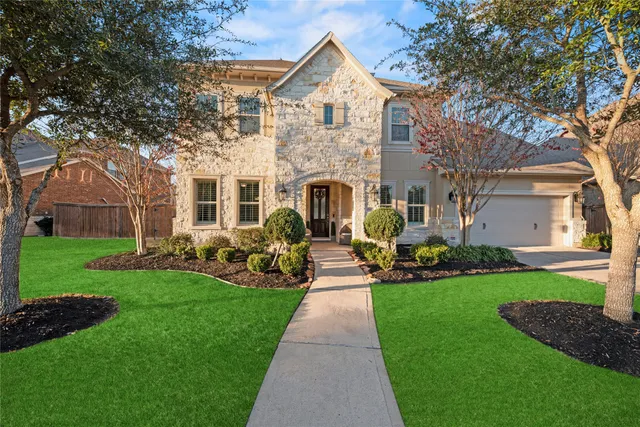 a front view of house with yard and green space