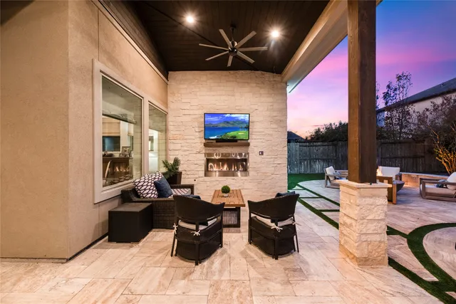 a living room with furniture a floor to ceiling window and a flat screen tv