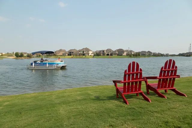 a view of a lake with lawn chairs