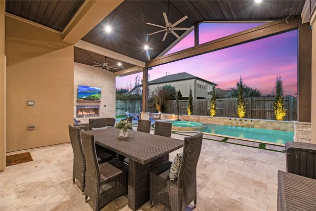 a view of a dining table and chairs in the patio